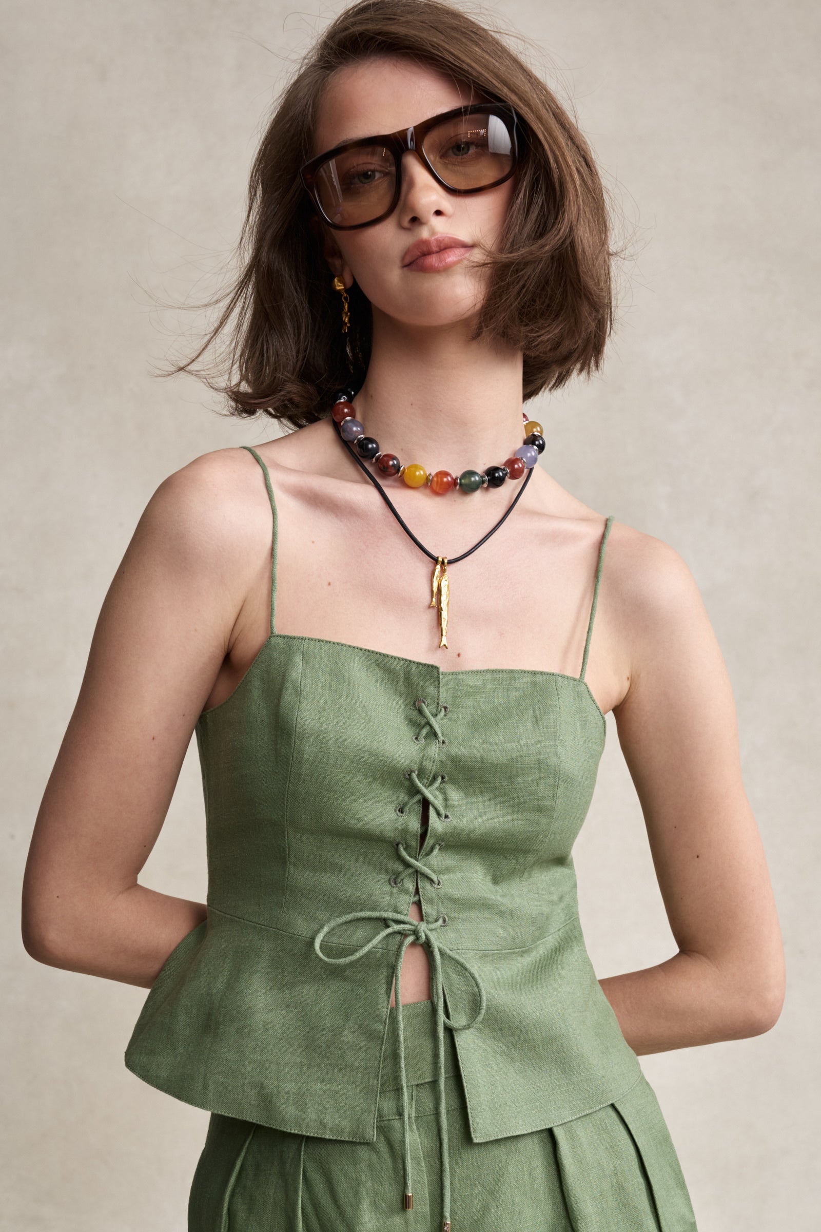 HEVRON Ophelia Linen Lace-Up Top in Sage, studio shot